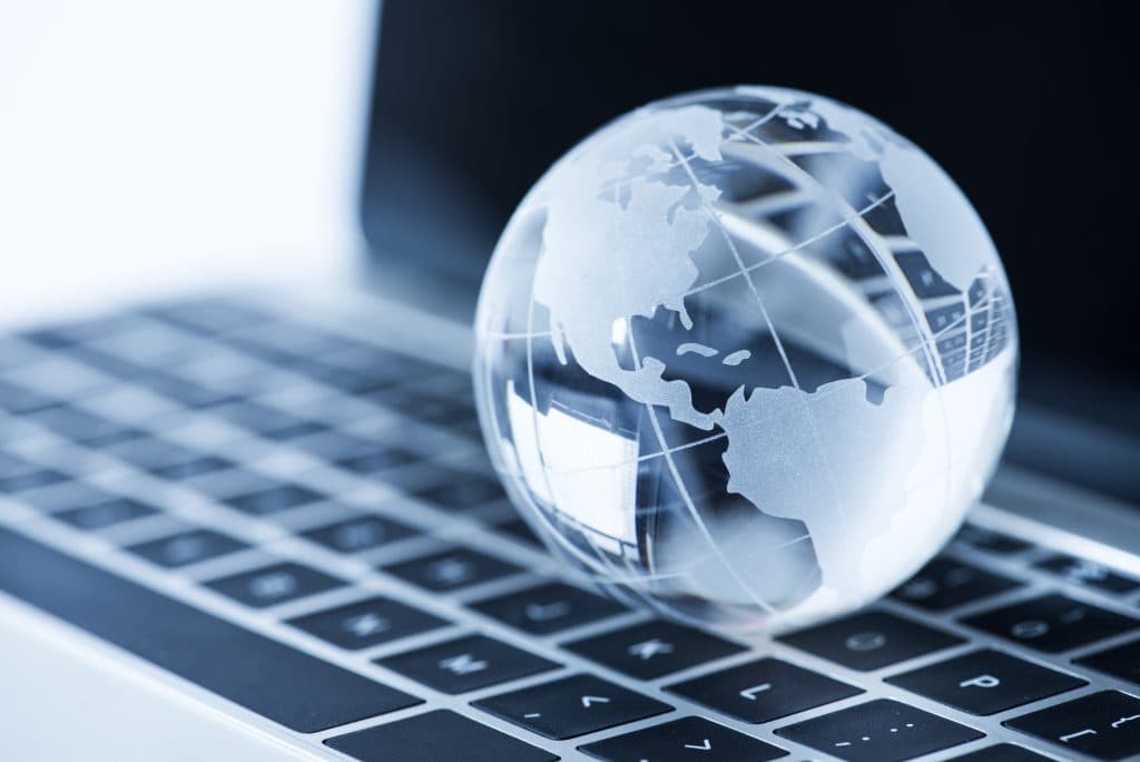 close up glass globe laptop 1024x684