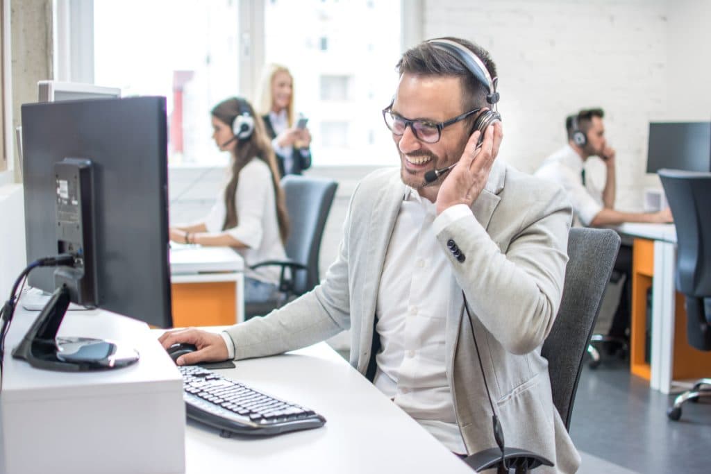 portrait happy smiling customer support phone operator workplace 1024x683
