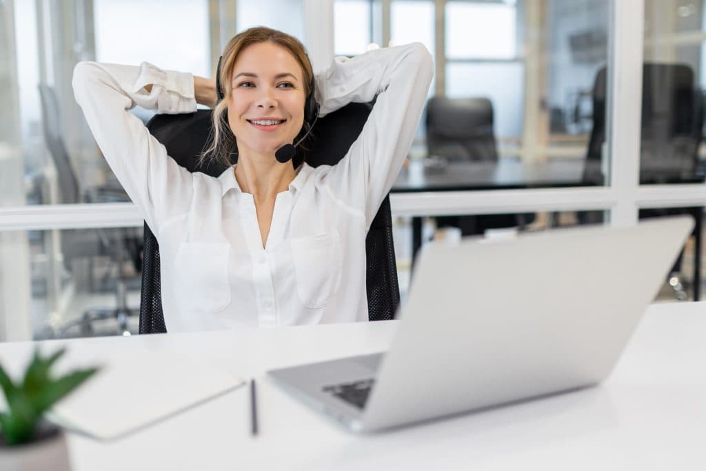 young woman sitting office stretching after long working day 1024x683